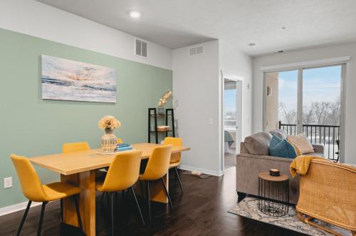 a living room with a table and chairs and a couch at NEW Shoreline 401 2BR Condo Near Downtown and Bay in Traverse City