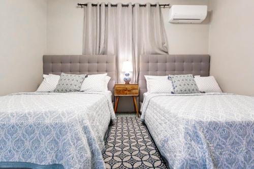 two beds sitting next to each other in a bedroom at Villa Esmeralda - Private Pool - Sleeps 18 Guest in Piedra Gorda