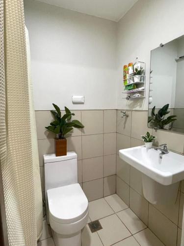 a bathroom with a toilet and a sink at Filed Residences Hotel Apartment in Manila