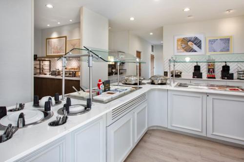 a large kitchen with two sinks and a counter at Staybridge Suites Omaha 80th and Dodge by IHG in Omaha