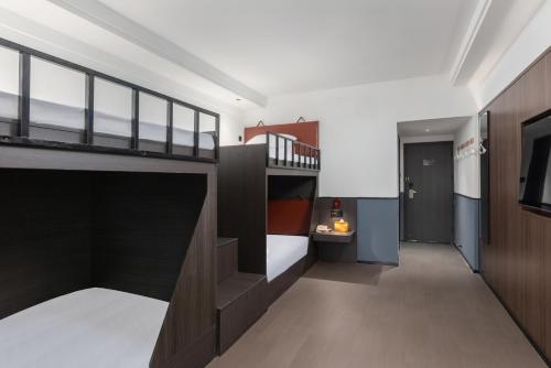 a bedroom with a bunk bed and a staircase at Mcsrh Hotel-Chengdu Jiuyanqiao in Chengdu
