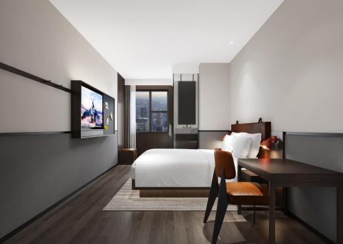 a hotel room with a bed and a desk at Mcsrh Hotel-Chengdu Jiuyanqiao in Chengdu