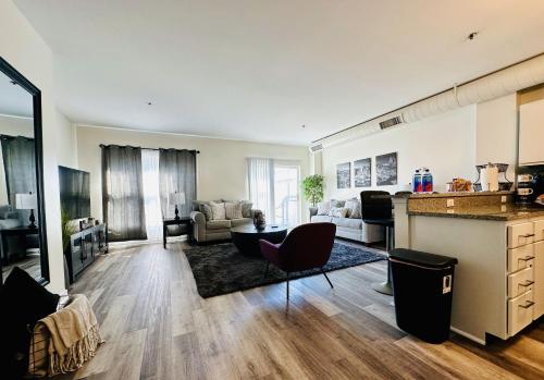a large living room with a kitchen and a living room at Downtown 2BR Penthouse Suite with Balcony and Direct Skybridge Access in Indianapolis