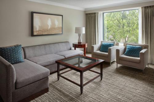 a living room with a couch and chairs and a table at Marriott Downtown at CF Toronto Eaton Centre in Toronto