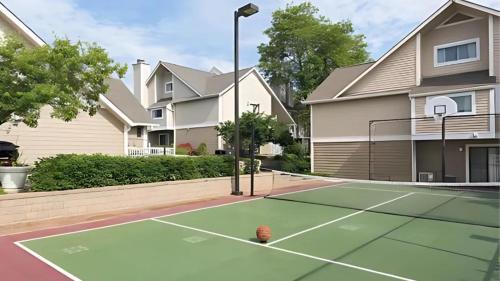 a tennis court in front of a house at Sonesta ES Suites Cincinnati - Sharonville West in Sharonville