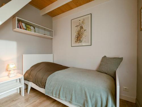 a bedroom with a bed in a white room at Maison indépendante avec terrasse et parking privatif - FR-1-591-719 in Le Poinçonnet