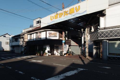 a building with a sign on the side of a street at 旅宿ときじくTokijiku in Nachikatsuura