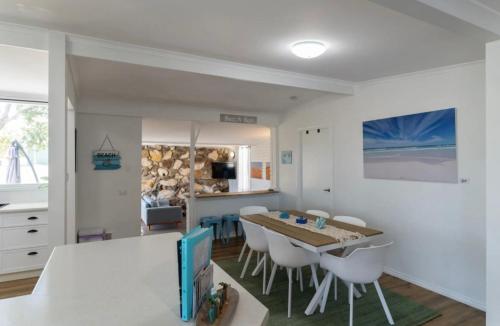 a kitchen and dining room with a table and chairs at Dolphins on Dalton in Jurien Bay