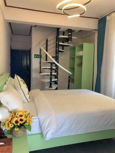 a bedroom with a bed and a spiral staircase at Vip KINGSON GUEST HOUSE in Luang Prabang