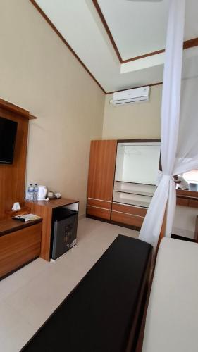 a living room with a couch and a window at Villa D'Carik Bali in Denpasar
