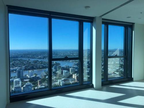 an empty room with large windows in an office building at Oasis Retreat on Level 71 in Skytower in Brisbane