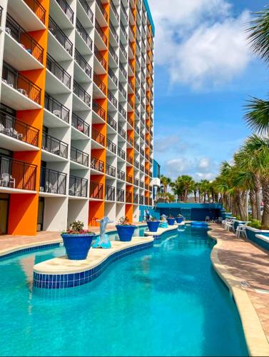 a swimming pool in front of a hotel at Ocean View 2 Queen Studio at Landmark Resort in Myrtle Beach