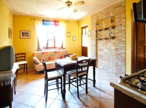 a dining room with a table and chairs and a fireplace at Da Ivana e Valter in Monforte dʼAlba