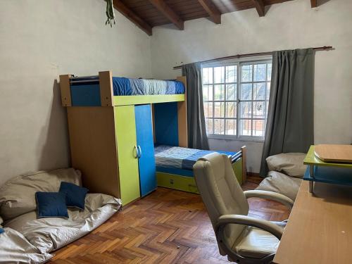 a room with a bunk bed and a couch at Spacious 3BDR house in Chivilcoy with swimming pool and view in Chivilcoy