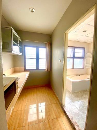 a kitchen with a sink and a tub in a room at Green Beach Pattaya in North Pattaya