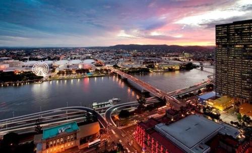 a view of a city with a river and a bridge at Hampton's Haven on Level 17 in Casino Towers in Brisbane