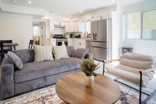 a living room with a couch and a table at Cozy LA Retreat Near USC Steps to Koreatown & Downtown in Los Angeles
