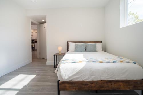 a bedroom with a large bed and a hallway at Cozy LA Retreat Near USC Steps to Koreatown & Downtown in Los Angeles