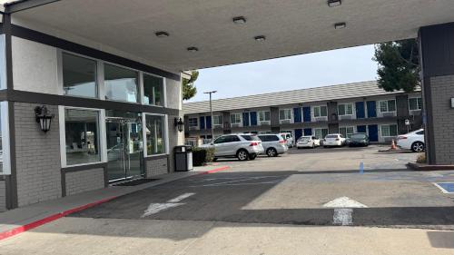 a parking lot with cars parked in front of a building at Studio 6 Corona, CA West in Corona