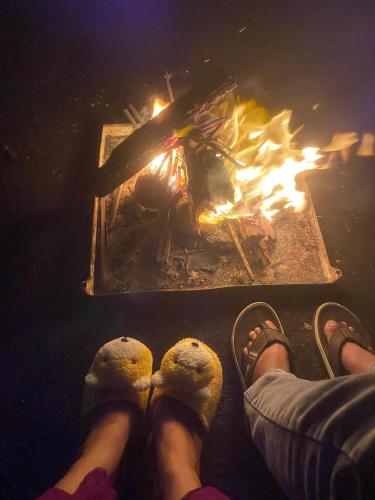 a person standing in front of a fire at Farah Guest Inn in Haputale