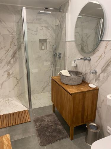 a bathroom with a sink and a shower at Les Hortensias in Canly