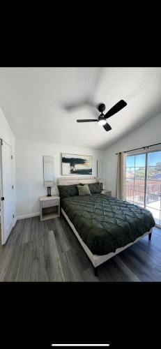 a bedroom with a bed and a ceiling fan at Blue Waterfalls in Las Vegas