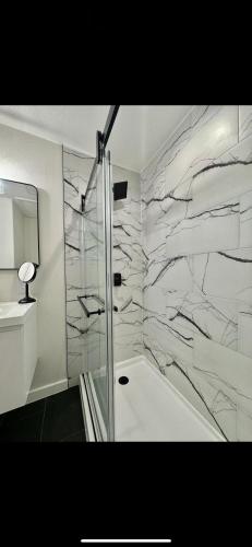 a bathroom with a shower with a marble wall at Blue Waterfalls in Las Vegas