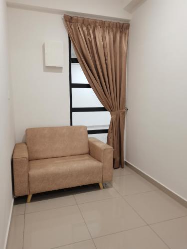 a living room with a couch and a window at Sunshine Residence in Ayer Itam