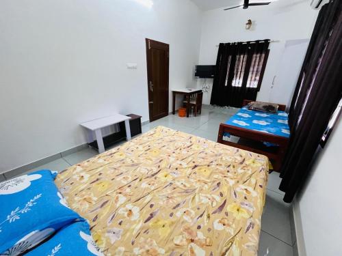 a bedroom with two beds in a room at Aagneyam mansion in Kozhikode