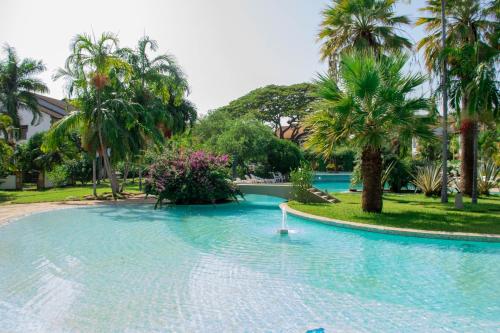 Una gran piscina con palmeras en un complejo turístico. en Marially luxury 2, en Malindi