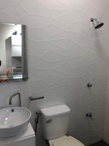 a bathroom with a white toilet and a sink at Scandinavian Studio with Highspeed internet in Bantug