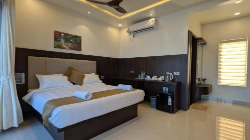 a bedroom with a large bed in a room at Leelas Coral Creek Inn in Udupi