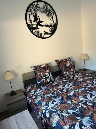 a bedroom with a bed and a clock on the wall at Maison de campagne avec piscine in Suze-la-Rousse