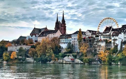a city on a hill next to a river at BC Apart 1 - Charming Apartment in City Center - Close to Rhine and Old Town in Basel