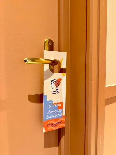 a doorhandle with a bag of dog food on it at Hôtel Gabriel in Menton