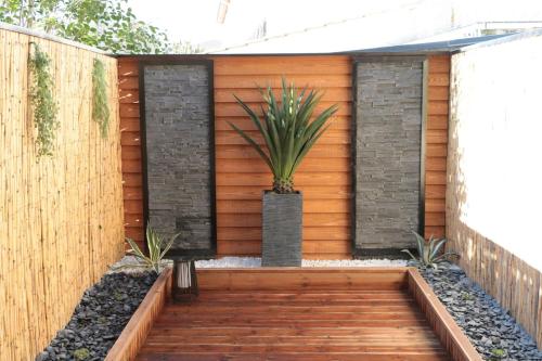 a wooden deck with a potted plant on it at Studio avec terrasse privative in Albi