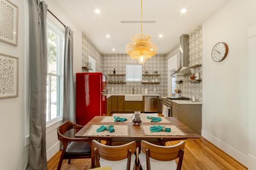 a kitchen with a table and a red refrigerator at Pleasure Pier Modern Home Nr Beach Bbq Games in Galveston