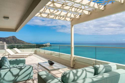 a balcony with chairs and a view of the ocean at Moana Surfrider, A Westin Resort & Spa, Waikiki Beach in Honolulu