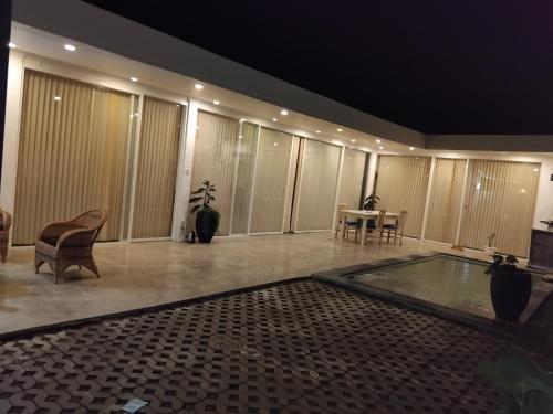 a large room with a swimming pool in a house at Villa harapan 2 in Kuta Lombok