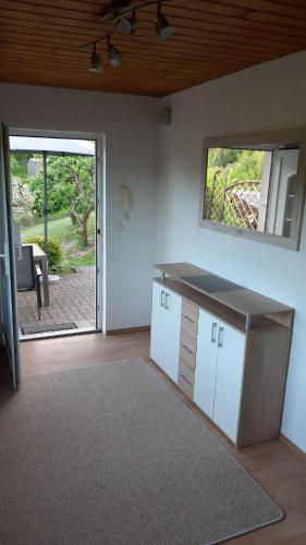 a living room with a counter and a sliding glass door at Ferienhaus im Grünen-Idyllischen Lage in Suhl
