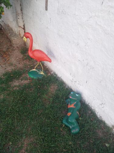 a toy bird standing on a skateboard next to a wall at CASA DE TEMPORADA RECANTO FELIz 2 in Aracaju