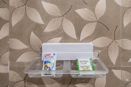 a plastic container with a package of food and toothpaste at Sam Residency in Puducherry