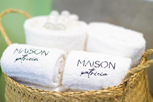 a basket filled with towels with the words mason bathroom at Maison Patricia in Lecce