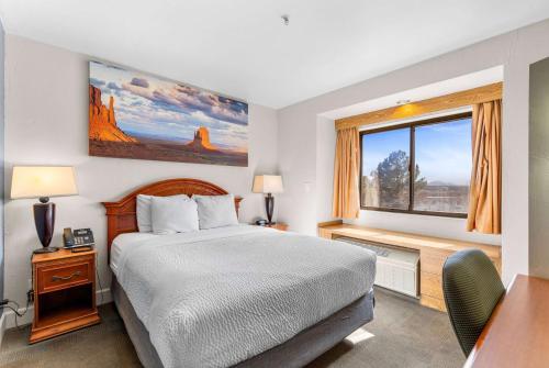 a hotel room with a bed and a window at Days Inn by Wyndham Camp Verde Arizona in Camp Verde