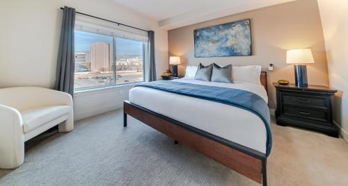 a bedroom with a large bed and a window at Expansive views - 1BD 1BA Hot Tub, Pool, Convention Centre in Salt Lake City