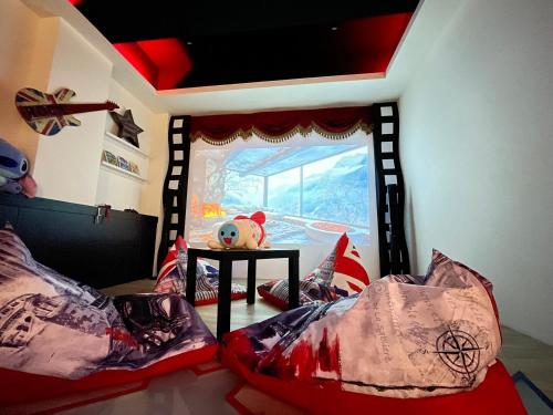 a room with two beds and a teddy bear on a table at 宜蘭I Do主題電梯民宿 in Wujie