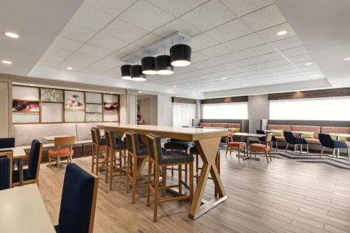 a waiting room with tables and chairs in a hospital at Hampton Inn Waynesboro/Stuarts Draft in Fishersville