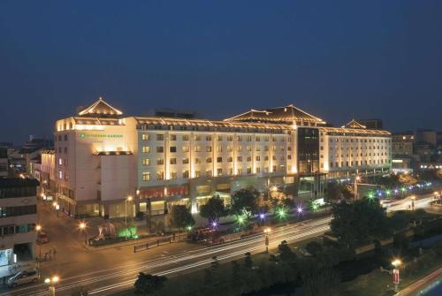 a large building at night with a street in front at Wyndham Garden Suzhou in Suzhou