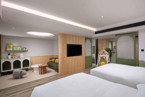 a bedroom with a bed and a tv and a fireplace at Days Hotel by Wyndham Changsha Yuhua West in Changsha