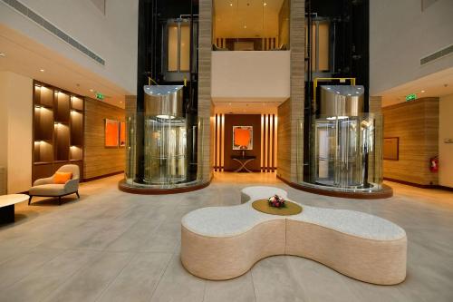 a lobby with a table in the middle of a room at Comfort Hotel Riyadh Olaya in Riyadh